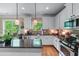 Bright kitchen with stainless steel appliances, hardwood floors, granite countertops, and scenic backyard views at 1645 Horseshoe Creek Ln, Cumming, GA 30041