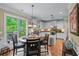 Eat-in kitchen features white cabinetry, hardwood floors, stainless steel appliances, granite counters, and a view of the backyard at 1645 Horseshoe Creek Ln, Cumming, GA 30041
