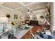 Comfortable living room featuring a fireplace, hardwood floors, coffered ceiling, and large windows at 1645 Horseshoe Creek Ln, Cumming, GA 30041