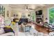 Bright living room featuring a fireplace, hardwood floors, coffered ceiling, and lots of natural light at 1645 Horseshoe Creek Ln, Cumming, GA 30041