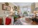 Cozy living room featuring hardwood floors, bay window providing natural light, and stylish seating for relaxing and entertaining at 1645 Horseshoe Creek Ln, Cumming, GA 30041