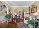 Open-concept living area featuring hardwood floors, staircase, and elegant archway leading to dining space creating a bright and airy at 1645 Horseshoe Creek Ln, Cumming, GA 30041