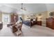 Spacious main bedroom with trey ceiling, ceiling fan, sitting area, and neutral color palette at 1645 Horseshoe Creek Ln, Cumming, GA 30041