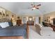 Bright main bedroom featuring a sitting area, a ceiling fan and a neutral color palette at 1645 Horseshoe Creek Ln, Cumming, GA 30041