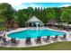Community pool featuring lounge chairs and mushroom fountain surrounded by lush greenery at 1645 Horseshoe Creek Ln, Cumming, GA 30041