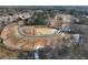 Aerial view of new home development highlighting a pond and homesites along a new road surrounded by trees at 2722 Byess Ct, Marietta, GA 30064