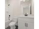 Clean bathroom featuring a white vanity, toilet and bathtub with black hardware and a large mirror at 2722 Byess Ct, Marietta, GA 30064