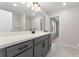 Modern bathroom with gray cabinets, quartz countertop, tiled floors, and neutral color palette at 2722 Byess Ct, Marietta, GA 30064