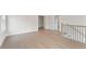 Hallway view with natural hardwood floors and stairwell access at 2722 Byess Ct, Marietta, GA 30064