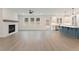 Bright and airy living room featuring hardwood floors, a white brick fireplace, and an open layout to the kitchen at 2722 Byess Ct, Marietta, GA 30064