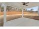 Covered back porch with a concrete floor, white pillars, and ceiling fan overlooking the backyard at 2722 Byess Ct, Marietta, GA 30064