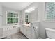 Bright bathroom with a soaking tub, a large window, and a modern vanity, creating a spa-like experience at 2986 Edenberry Nw Ln, Kennesaw, GA 30152