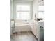 Well-lit bathroom with a soaking tub, large window, and a vanity with ample counter space at 2986 Edenberry Nw Ln, Kennesaw, GA 30152