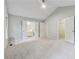 Spacious bedroom showcasing plush carpeting, a ceiling fan, and ensuite bathroom and closet access at 2986 Edenberry Nw Ln, Kennesaw, GA 30152