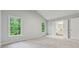 Spacious bedroom with neutral carpet, two windows, and attached bathroom at 2986 Edenberry Nw Ln, Kennesaw, GA 30152