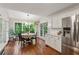 Bright breakfast nook featuring hardwood floors and large windows showcasing the lush outdoor scenery at 2986 Edenberry Nw Ln, Kennesaw, GA 30152