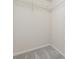 Walk-in closet featuring carpeted flooring and white wire shelving, offering ample storage space at 2986 Edenberry Nw Ln, Kennesaw, GA 30152