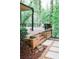 Elevated wood deck and patio with steps and built in planters surrounded by mature trees at 2986 Edenberry Nw Ln, Kennesaw, GA 30152