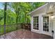 Spacious wood deck overlooking lush greenery and mature trees, accessible from a door at 2986 Edenberry Nw Ln, Kennesaw, GA 30152