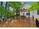 Large outdoor patio and wood deck areas surrounded by lush green trees and foliage at 2986 Edenberry Nw Ln, Kennesaw, GA 30152
