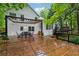 Wide shot of back of a white home with an outdoor patio area and wood deck at 2986 Edenberry Nw Ln, Kennesaw, GA 30152