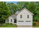 Beautiful home featuring a lush green lawn, mature trees, and a two-car garage at 2986 Edenberry Nw Ln, Kennesaw, GA 30152