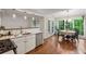 Kitchen with hardwood floors, stainless steel appliances, and a bright breakfast nook overlooking lush greenery at 2986 Edenberry Nw Ln, Kennesaw, GA 30152
