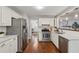 Bright kitchen featuring stainless steel appliances, white cabinets, and hardwood flooring at 2986 Edenberry Nw Ln, Kennesaw, GA 30152