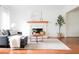 Comfortable living room with a cozy fireplace, a plush sofa, and hardwood floors at 2986 Edenberry Nw Ln, Kennesaw, GA 30152