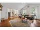 Inviting living room with vaulted ceilings, hardwood flooring, neutral decor, and seamless access to the staircase at 2986 Edenberry Nw Ln, Kennesaw, GA 30152