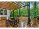 Spacious outdoor patio with dining table under a wooden pergola and lush green scenery at 2986 Edenberry Nw Ln, Kennesaw, GA 30152