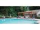 Community pool area with lounge chairs, tables, and a wooden pergola for shade at 2986 Edenberry Nw Ln, Kennesaw, GA 30152