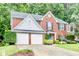 Beautiful brick home with a manicured lawn and two-car garage at 3168 Kirkwood Nw Dr, Kennesaw, GA 30144