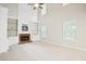 Spacious living room with high ceilings, fireplace, built-in shelves, and lots of natural light at 3168 Kirkwood Nw Dr, Kennesaw, GA 30144