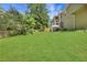Spacious backyard showcasing a well-maintained lawn, fence line, and elevated deck area at 3820 Pheasant Run Trce, Cumming, GA 30028