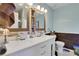 Modern bathroom featuring a dual sink vanity, a wood accent wall, and a mirror at 3820 Pheasant Run Trce, Cumming, GA 30028