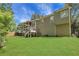 Rear exterior showing an expansive lawn, two story deck and lush surrounding trees at 3820 Pheasant Run Trce, Cumming, GA 30028
