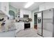 Bright kitchen featuring white cabinetry, granite countertops, stainless steel appliances, and modern finishes at 3820 Pheasant Run Trce, Cumming, GA 30028