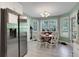 Bright breakfast area featuring white cabinetry, stainless steel appliances, and large windows at 3820 Pheasant Run Trce, Cumming, GA 30028