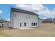 Exterior view of the home showcasing its backyard and patio at 406 Westmarch Cir, Loganville, GA 30052