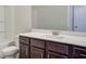 This bathroom features a vanity with dark cabinets, white countertop, and a large mirror at 406 Westmarch Cir, Loganville, GA 30052