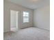 A bright bedroom with plush carpeting and a walk-in closet at 406 Westmarch Cir, Loganville, GA 30052