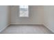 Empty closet with carpet and a window with a view of a neighboring home at 406 Westmarch Cir, Loganville, GA 30052