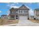 Attractive two-story home with brick and siding, complemented by a concrete driveway and landscaping at 406 Westmarch Cir, Loganville, GA 30052