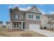 Beautiful two-story home with a brick and siding exterior, two-car garage, and manicured lawn at 406 Westmarch Cir, Loganville, GA 30052