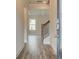 Inviting foyer showcasing wood floors, staircase with wooden banister, and views into the living area at 406 Westmarch Cir, Loganville, GA 30052