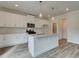 Stylish kitchen with white cabinets, granite countertops, stainless steel appliances, and wood floors at 406 Westmarch Cir, Loganville, GA 30052
