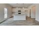 Bright kitchen features white cabinets, grey countertops, stainless steel appliances, and a large island at 406 Westmarch Cir, Loganville, GA 30052