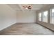 Bright living room featuring tray ceilings, wood floors, and large windows offering plenty of natural light at 406 Westmarch Cir, Loganville, GA 30052