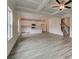 Open-concept living space with tray ceilings, wood floors, a staircase, and a modern kitchen at 406 Westmarch Cir, Loganville, GA 30052
